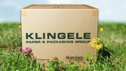 Corrugated cardboard packaging on a flower meadow Corrugated cardboard packaging on a flower meadow